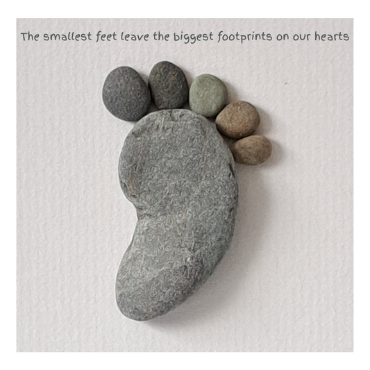 Footprint-shaped stones on a textured surface with a motivational quote.