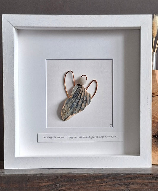 A guardian angel created from a natually shaped shell and beach pebble with copper wings