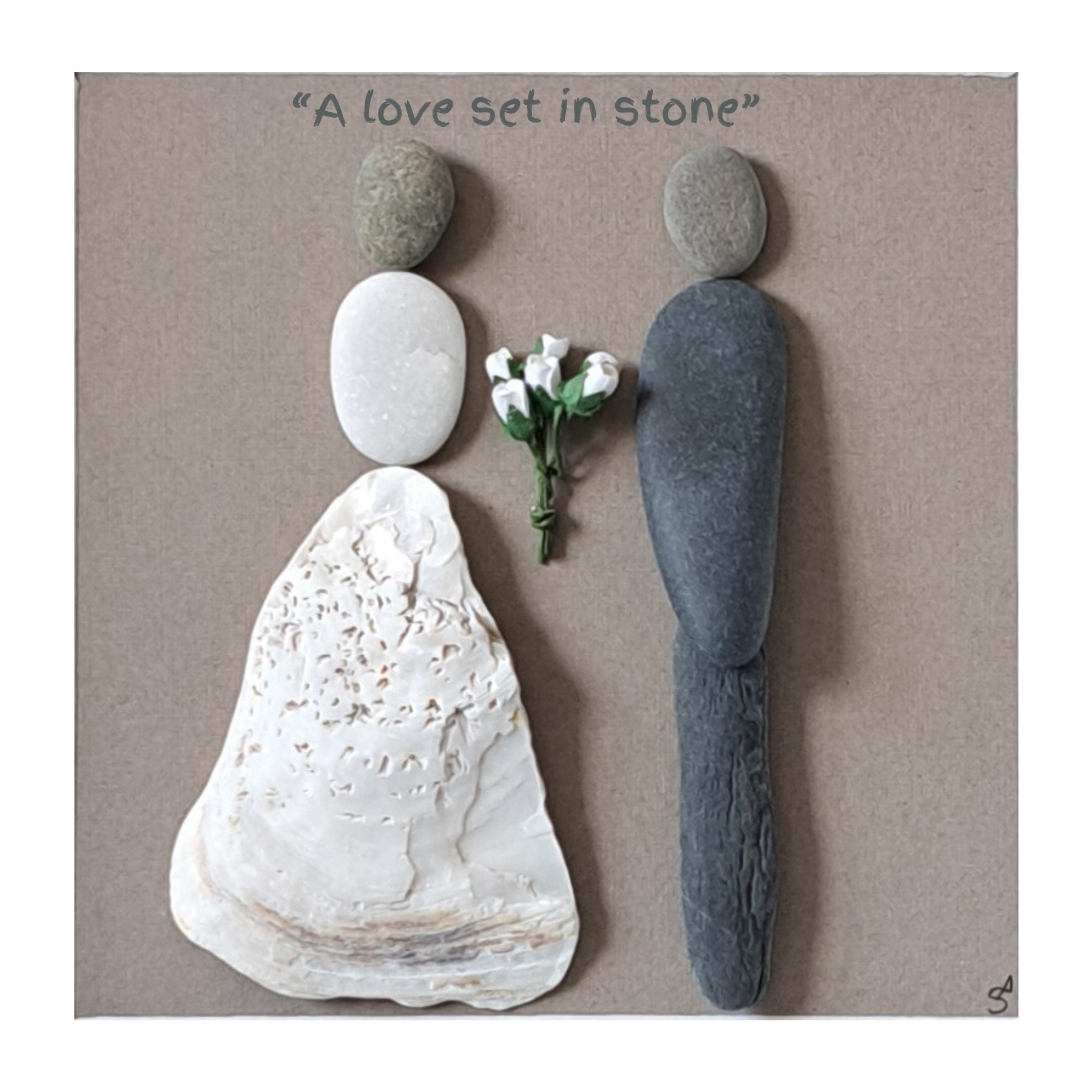 Artistic arrangement of beach pebbles and shells shaped like a bride and groom  with a bouquet on a brown background.